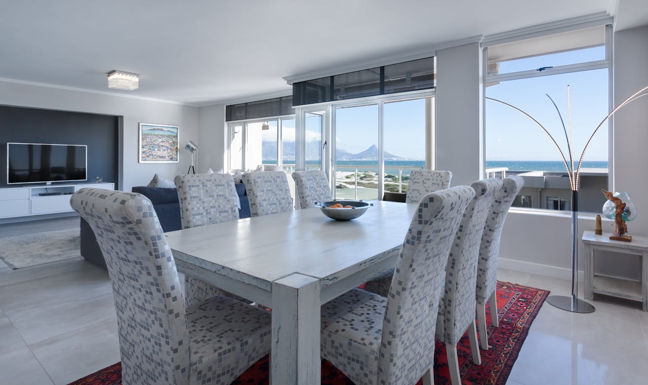 awards-img Luxurious dining room in Cape Town with modern furniture and ocean views.